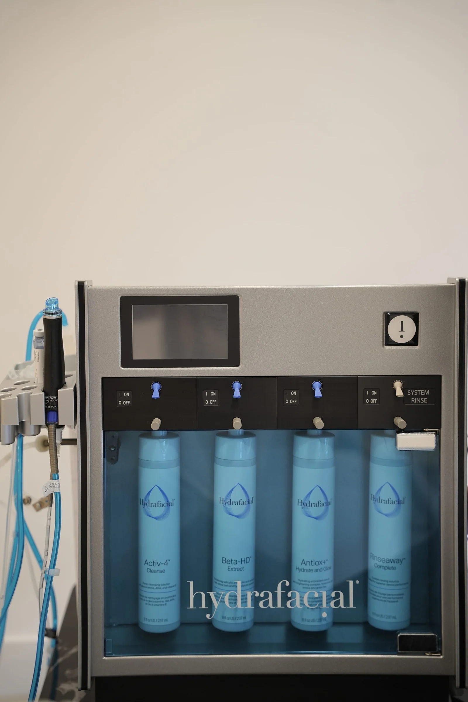 A Hydrafacial system with its four serum cartridges